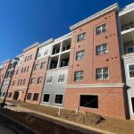 Brick and gray apartment complex.