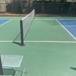 Tennis court with green and blue ground.